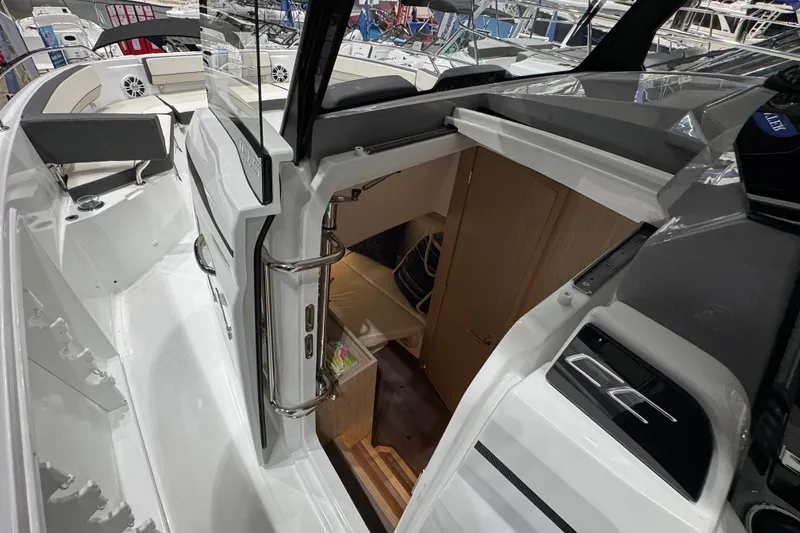 Slide: The Image of 2026 Jeanneau Leader 10.5 CC boat interior with cabin entrance and seating area. - 11