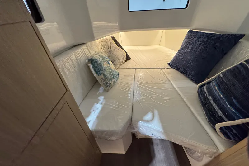 Slide: The Image of Cozy cabin interior of 2026 Jeanneau Leader 10.5 CC with plush cushions. - 14