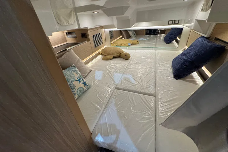 Slide: The Image of Interior cabin of 2026 Jeanneau Leader 10.5 CC with plush seating and pillows. - 15