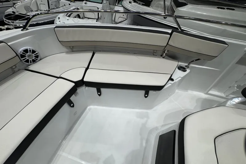 Slide: The Image of 2026 Jeanneau Leader 10.5 CC boat interior with cushioned seating and speaker. - 19