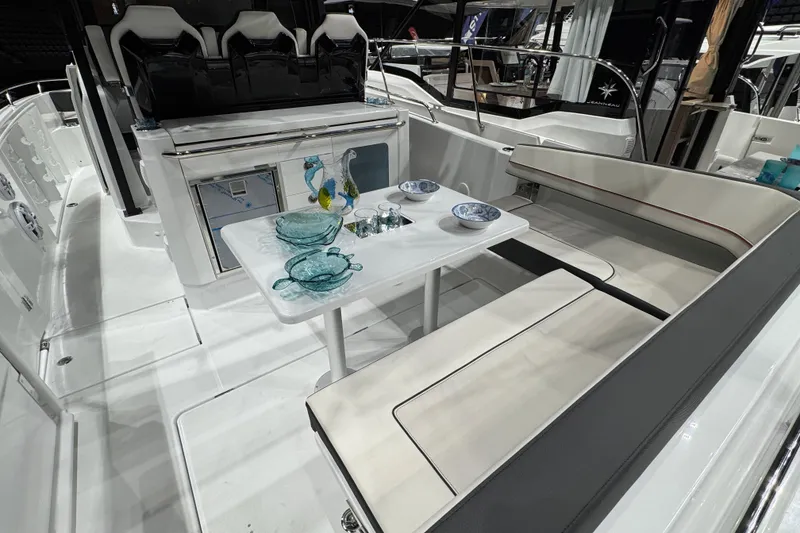 Slide: The Image of 2026 Jeanneau Leader 10.5 CC boat interior with seating and dining area. - 2