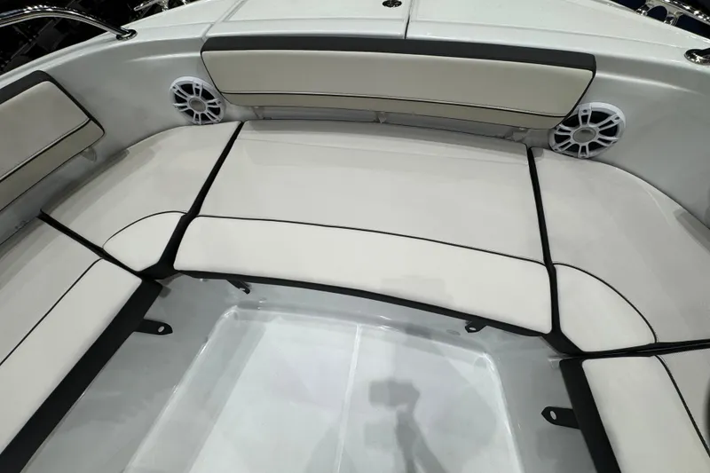 Slide: The Image of 2026 Jeanneau Leader 10.5 CC boat interior with cushioned seating and speakers. - 20