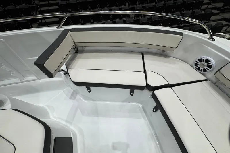 Slide: The Image of 2026 Jeanneau Leader 10.5 CC boat interior with cushioned seating and speaker. - 21