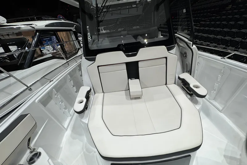 Slide: The Image of 2026 Jeanneau Leader 10.5 CC boat interior with white seating and cup holders. - 22
