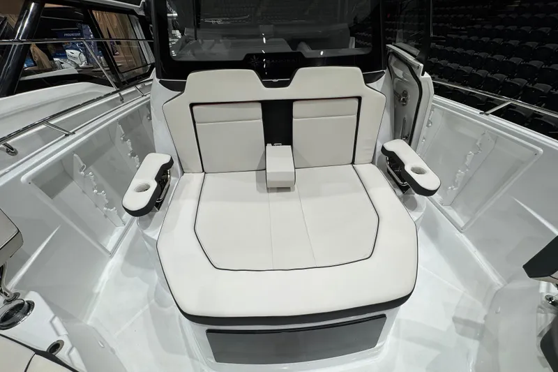 Slide: The Image of 2026 Jeanneau Leader 10.5 CC boat interior with white seating and armrests. - 23