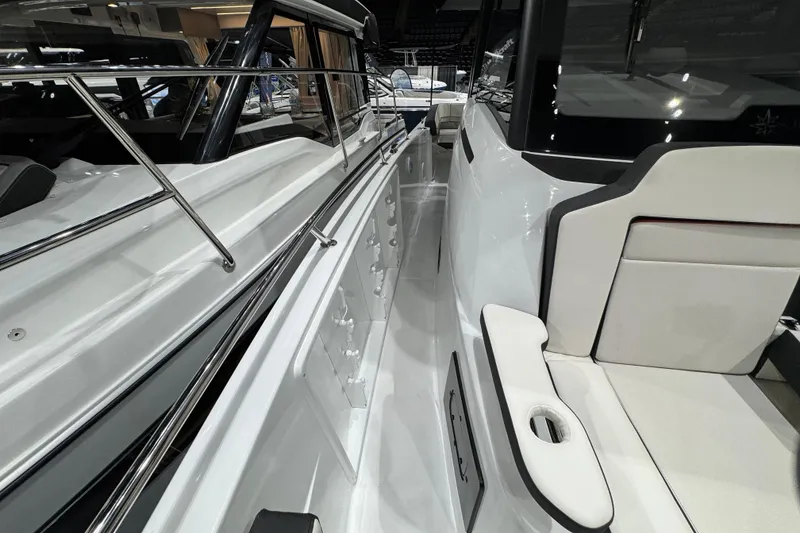 Slide: The Image of 2026 Jeanneau Leader 10.5 CC boat interior with sleek seating and polished railings. - 25
