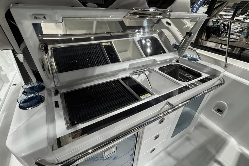 Slide: The Image of Outdoor kitchen on 2026 Jeanneau Leader 10.5 CC boat with grill and sink. - 4