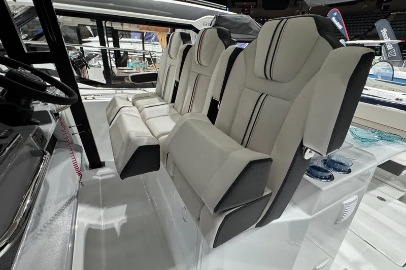 Slide: The Image of 2026 Jeanneau Leader 10.5 CC boat interior with modern seating and steering wheel. - 6