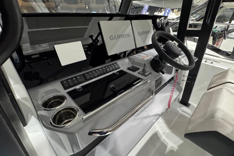 Slide: The Image of 2026 Jeanneau Leader 10.5 CC cockpit with Garmin displays and modern controls. - 7