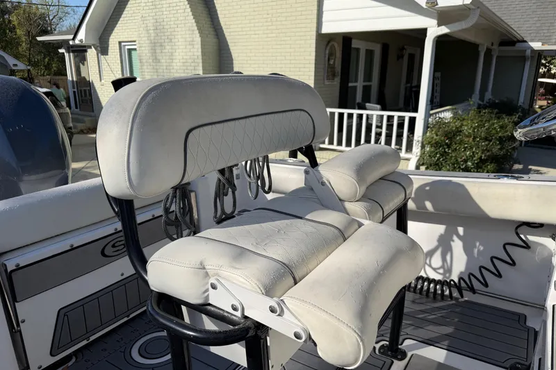 Slide: The Image of 2020 Sportsman Open 212 Center Console boat seat, white upholstery, outdoor setting. - 10