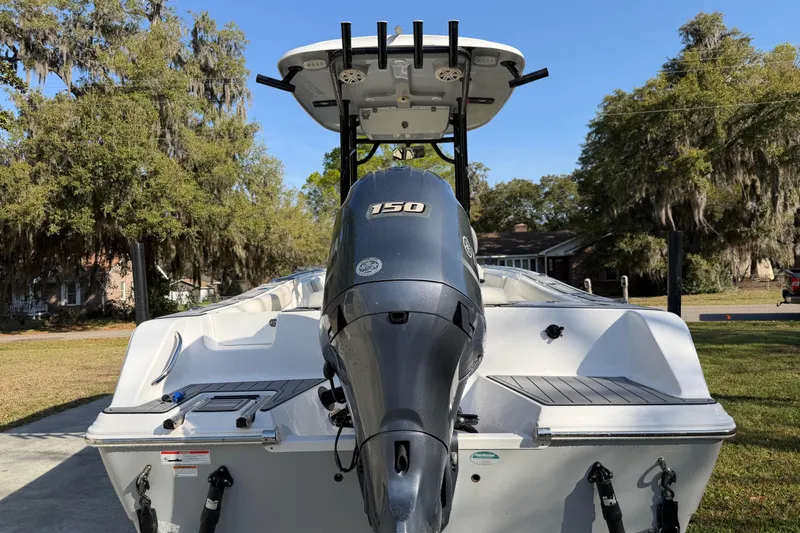 Slide: The Image of 2020 Sportsman Open 212 Center Console boat with 150 HP engine, parked outdoors. - 5