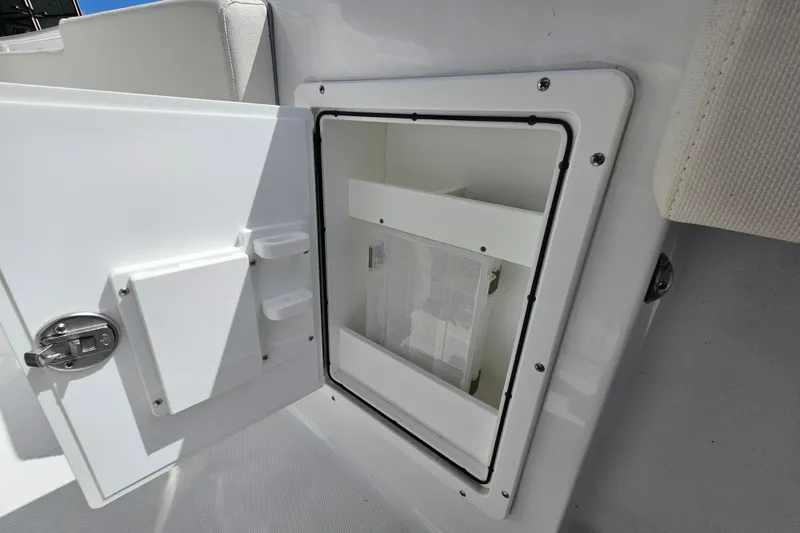 Slide: The Image of Open storage compartment on 2025 Sea Hunt Ultra 275 SE boat. - 12
