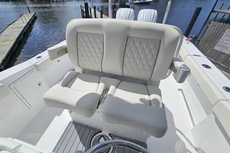 Slide: The Image of Luxury seating on 2025 Sea Hunt Ultra 275 SE boat, dockside view. - 17