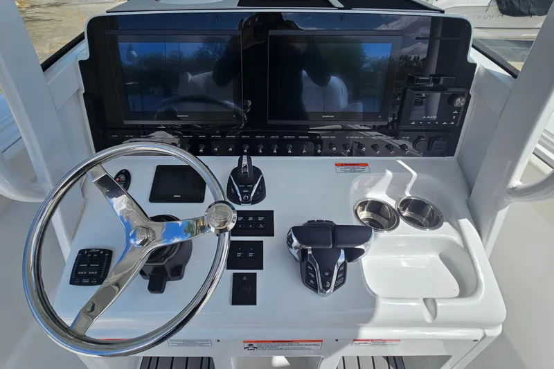 Slide: The Image of 2025 Sea Hunt Ultra 275 SE helm with dual screens and modern controls. - 19