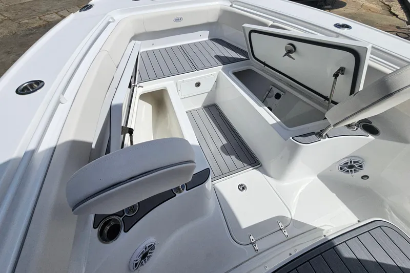 Slide: The Image of 2025 Sea Hunt Ultra 275 SE boat interior with open storage compartments and seating. - 23