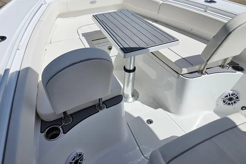 Slide: The Image of 2025 Sea Hunt Ultra 275 SE boat interior with seating and table. - 26