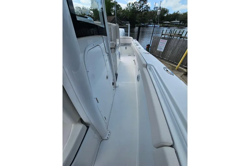 Slide: The Image of 2025 Sea Hunt Ultra 275 SE boat interior, showcasing sleek design and spacious walkway. - 28