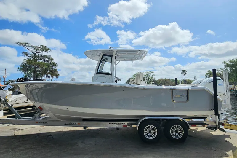 Slide: The Image of 2025 Sea Hunt Ultra 275 SE boat on trailer under blue sky. - 3