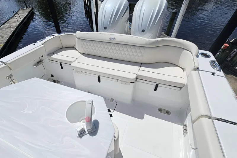 Slide: The Image of 2025 Sea Hunt Ultra 275 SE boat interior with white seating and dual engines. - 8