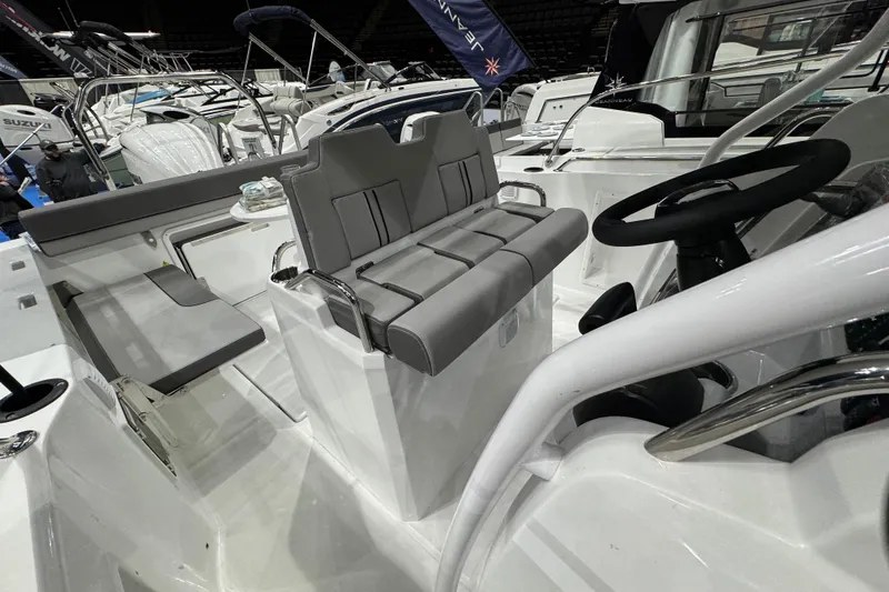 Slide: The Image of 2026 Jeanneau Cap Camarat 7.5 CC Serie 3 boat interior with steering wheel and seating. - 14
