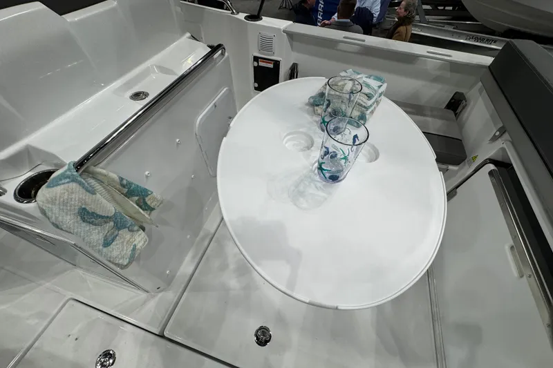 Slide: The Image of Interior of 2026 Jeanneau Cap Camarat 7.5 CC Serie 3 with table and glasses. - 2