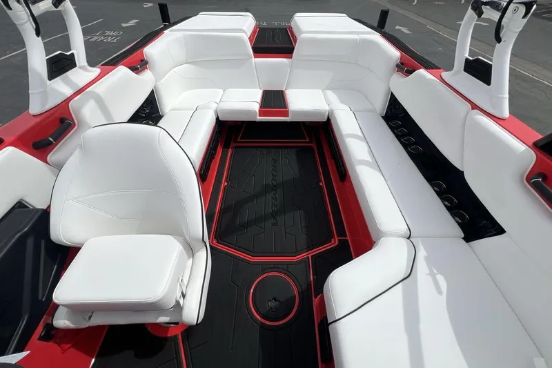 Slide: The Image of 2025 Moomba Max boat interior with white seating and red accents. - 10