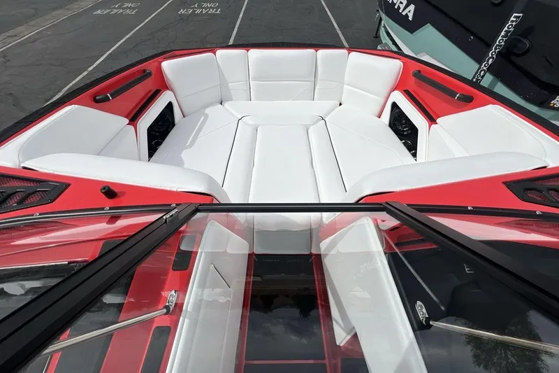 Slide: The Image of 2025 Moomba Max boat interior with white seating and red accents. - 11