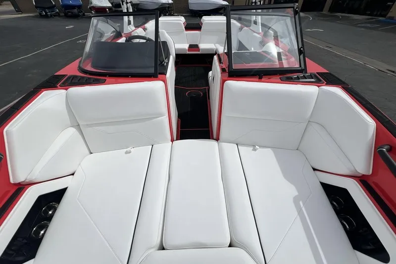 Slide: The Image of 2025 Moomba Max boat interior with white seating and red accents. - 12
