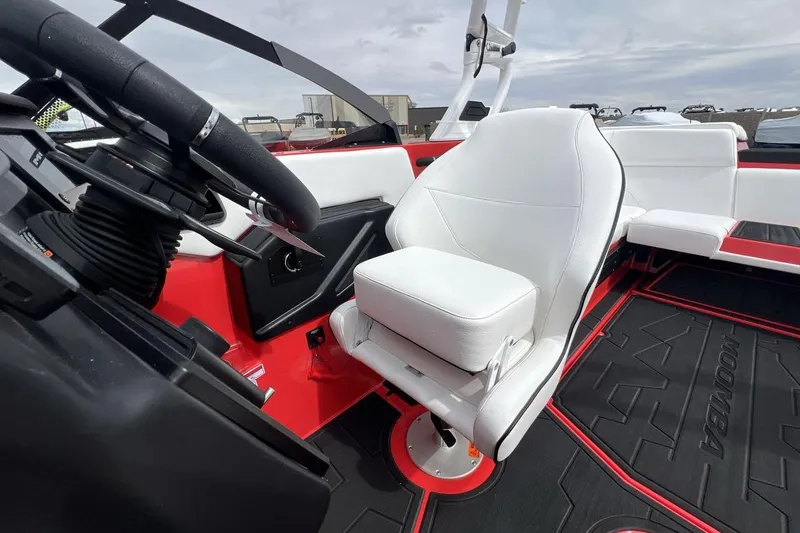 Slide: The Image of 2025 Moomba Max boat interior with white seating and red accents. - 13