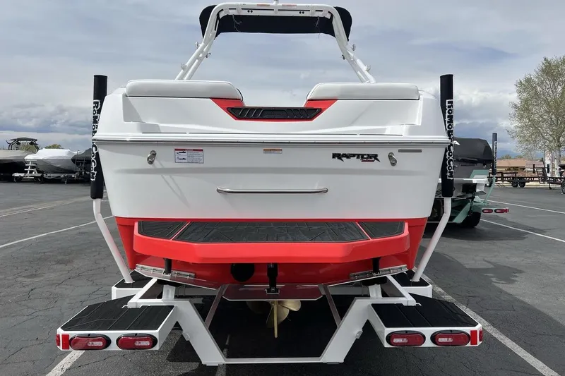 Slide: The Image of 2025 Moomba Max boat rear view with red accents and Raptor engine branding. - 4