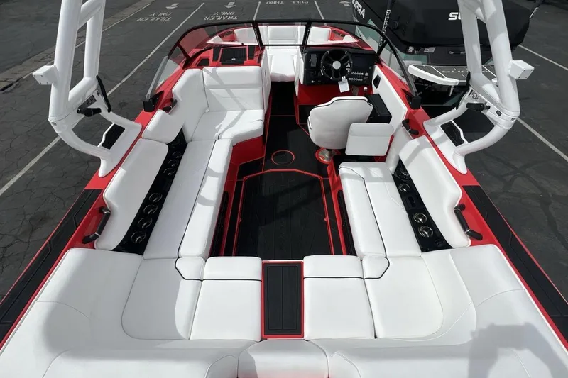 Slide: The Image of 2025 Moomba Max boat interior with white seating and red accents, showcasing spacious design. - 9