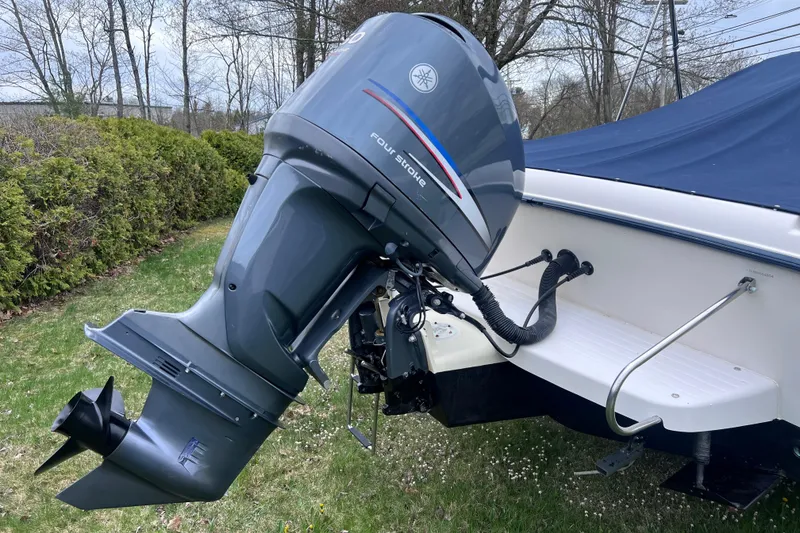 Slide: The Image of 2004 Grady-White Tournament 225 boat with Yamaha outboard motor, parked on grass. - 11