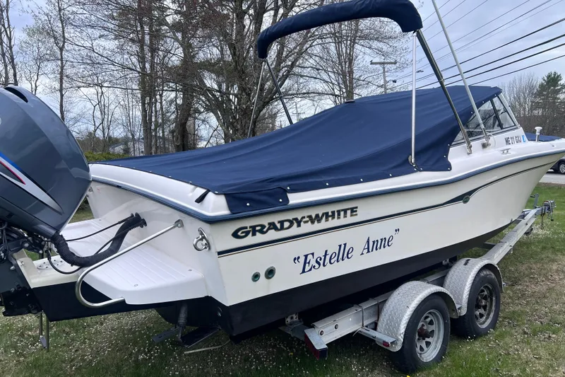 Slide: The Image of 2004 Grady-White Tournament 225 boat named "Estelle Anne" on trailer, covered and parked. - 3