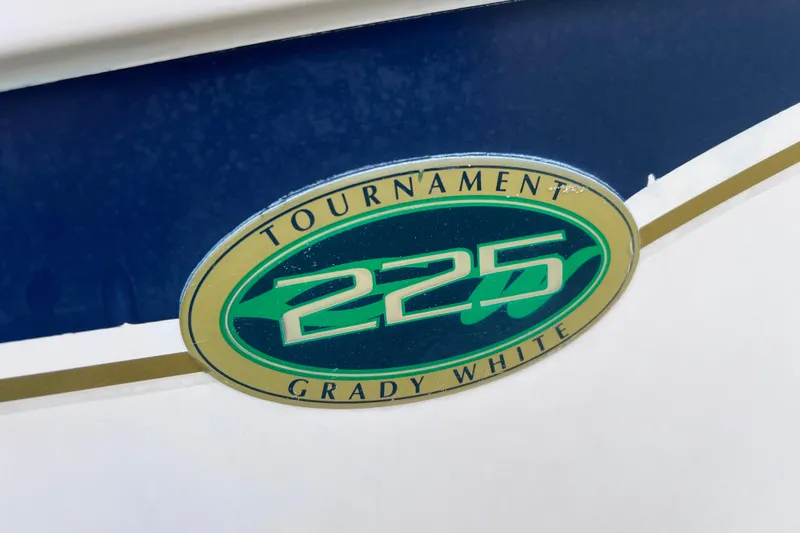 Slide: The Image of Grady-White Tournament 225 logo on a 2004 model boat, featuring blue and green design. - 6