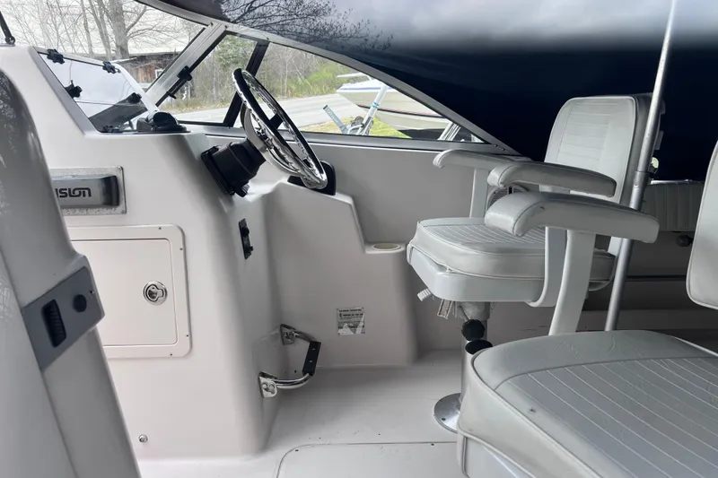 Slide: The Image of 2004 Grady-White Tournament 225 boat interior with steering wheel and seating. - 7