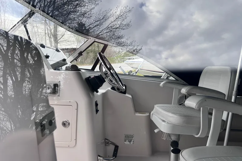 Slide: The Image of Interior of 2004 Grady-White Tournament 225 boat with steering wheel and seating. - 8