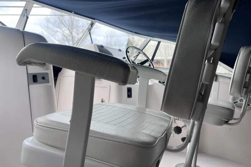 Slide: The Image of Interior of 2004 Grady-White Tournament 225 boat with white seating and steering wheel. - 9