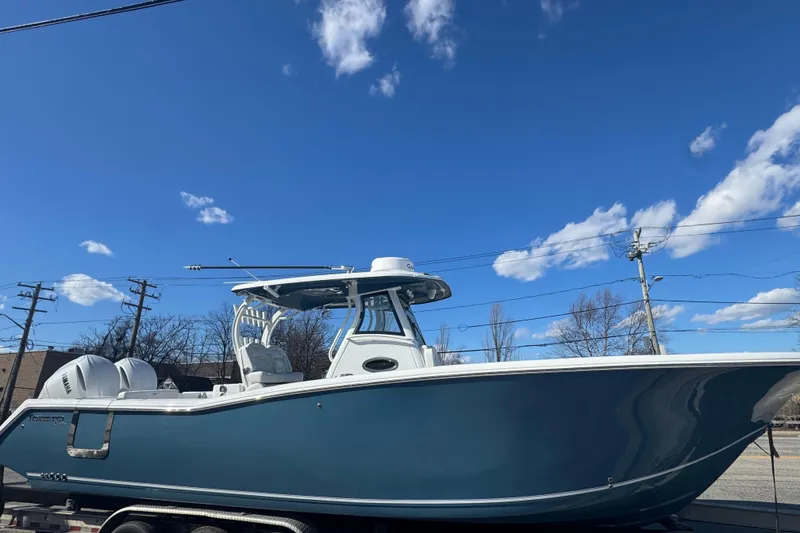 The Image of 2026 Tidewater 320 CC Adventure boat under clear blue sky. - 1