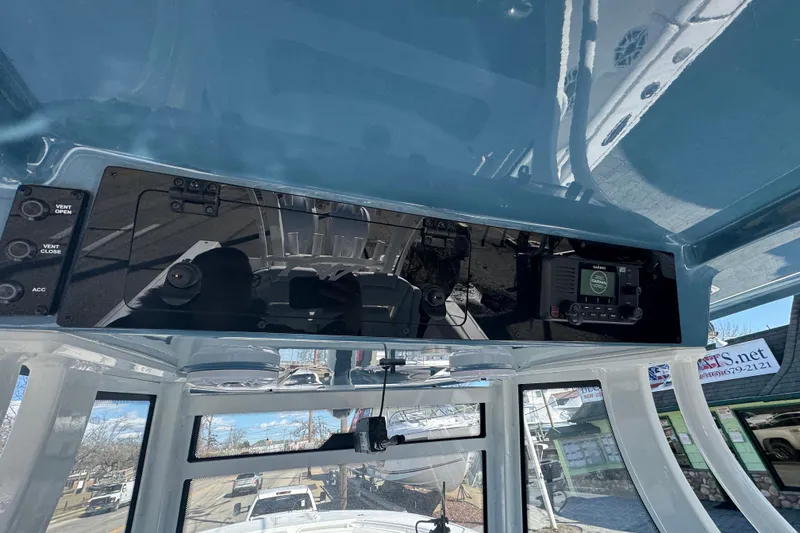 Slide: The Image of 2026 Tidewater 320 CC Adventure boat dashboard with navigation controls and display. - 11