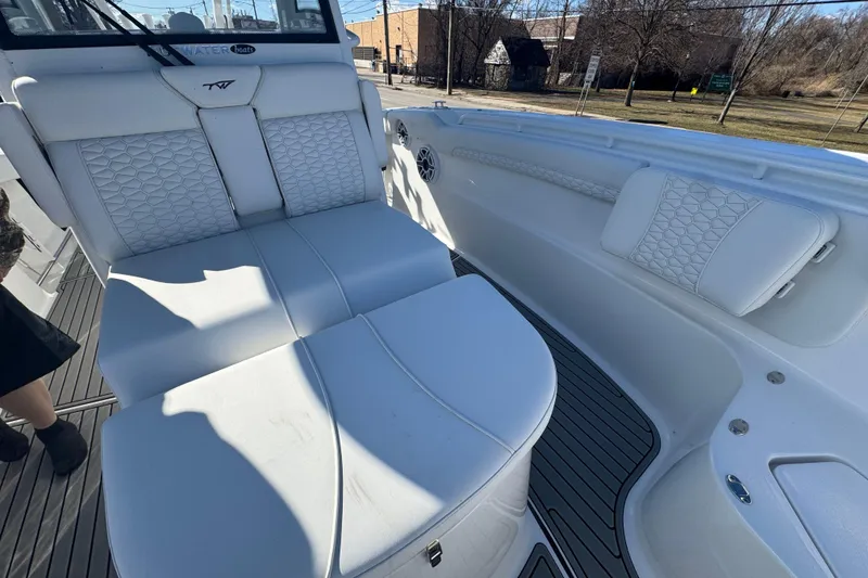 Slide: The Image of 2026 Tidewater 320 CC Adventure boat interior with white cushioned seating and sleek design. - 15