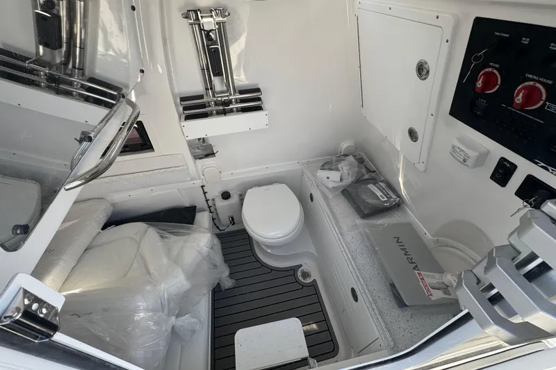 Slide: The Image of 2026 Tidewater 320 CC Adventure boat interior with toilet and control panel. - 16