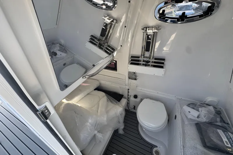 Slide: The Image of 2026 Tidewater 320 CC Adventure boat interior with modern bathroom amenities. - 17