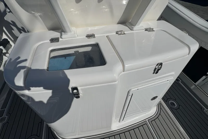 Slide: The Image of 2026 Tidewater 320 CC Adventure boat console with storage compartments and sleek design. - 4