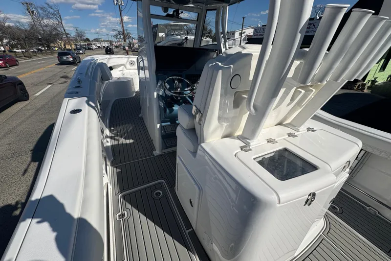Slide: The Image of 2026 Tidewater 320 CC Adventure boat interior with rod holders and steering wheel. - 6