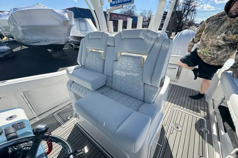 Slide: The Image of 2026 Tidewater 320 CC Adventure boat interior with plush seating and modern design. - 7