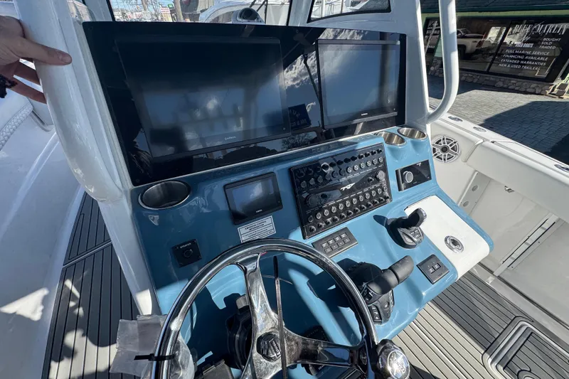 Slide: The Image of Helm of 2026 Tidewater 320 CC Adventure boat with advanced controls and displays. - 8