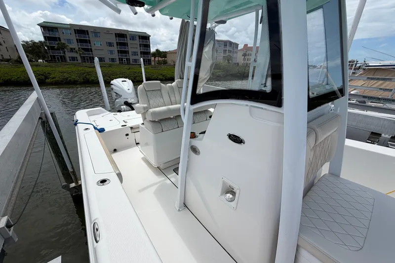 Slide: The Image of 2022 Blue Wave 2800 Pure Hybrid boat docked, featuring sleek design and comfortable seating. - 10