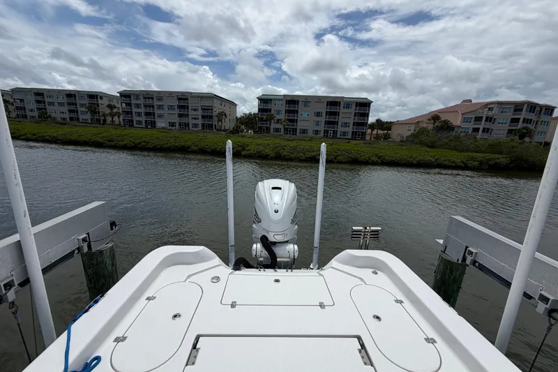 Slide: The Image of 2022 Blue Wave 2800 Pure Hybrid boat docked by waterfront buildings under cloudy sky. - 12