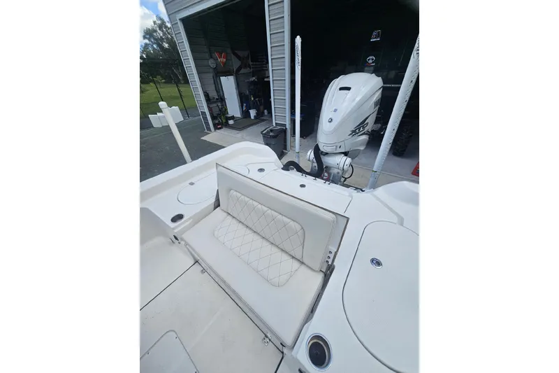 Slide: The Image of 2022 Blue Wave 2800 Pure Hybrid boat with open storage compartment and visible outboard motor. - 16