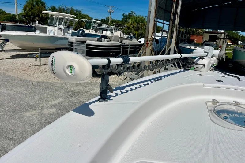 Slide: The Image of 2022 Blue Wave 2800 Pure Hybrid boat with trolling motor in a marina setting. - 25